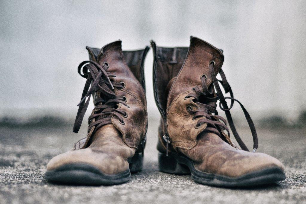Two tatty old brown men's boots