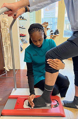 Consultant at Foot Solutions Richmond obtaining a 3D impression of customer's foot