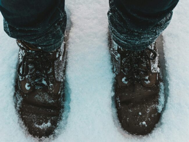 Person wearing walking boots in snowy conditions